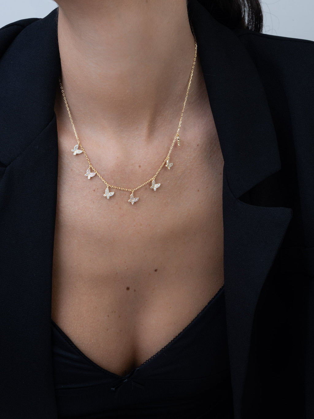 Gold-plated butterfly charm necklace with pink zirconias